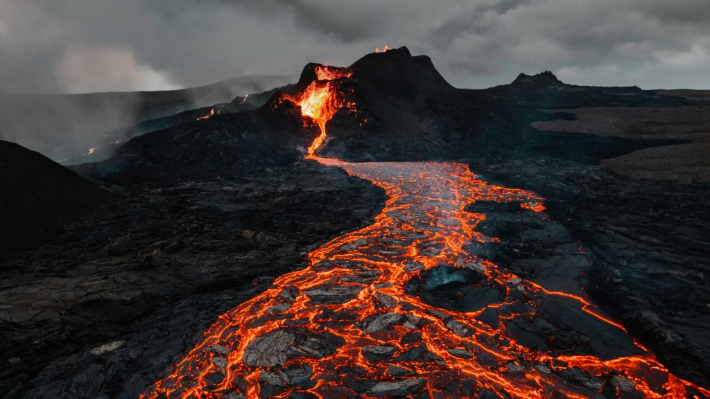 Icelandic volcano erupting with molten lava under dark skies